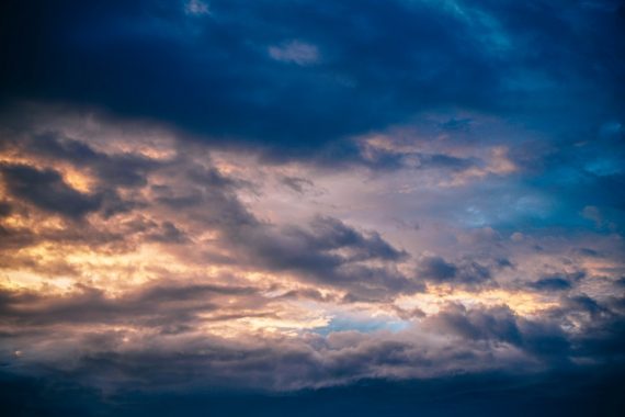 Dark purple and blue grey clouds with light filtering through to symbolise how to relieve depression