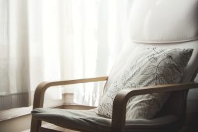 Empty white chair against white curtain in therapist's room, symbolising psychologist vacancies and psychologist practice