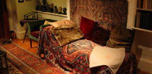 Freud couch psychotherapy office in London with rugs and sofa for therapy session