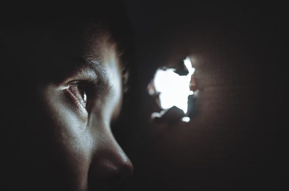 Child hiding from outside world safeguarding safety and security inside box