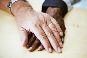 Support and friendship through clasped hands