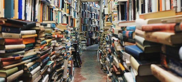 Piles of books floor to ceiling as hoarding depiction