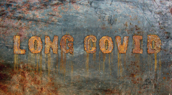 Rusted panel with lettering spelling out 'Long Covid' in capitals.