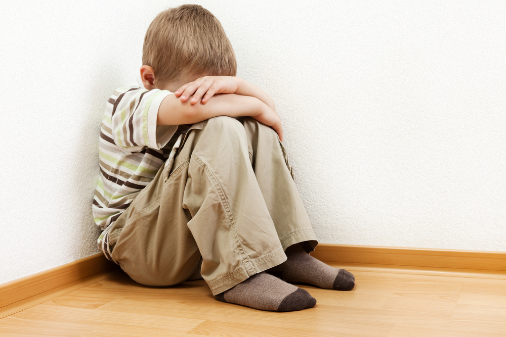 sad child sitting on the floor