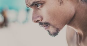 Determined facial expression and focusing on goal or target in portrait of man