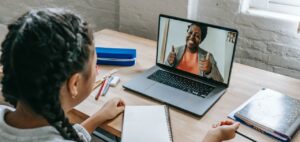 Pupil having online lesson on laptop from home