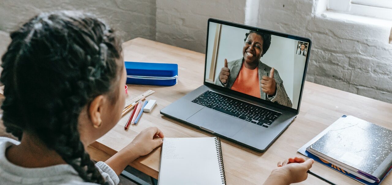 Pupil having online lesson on laptop from home